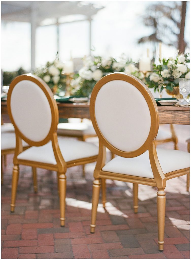 White and gold wedding reception chairs from RW Rentals at Cypress Grove Estate House || The Ganeys
