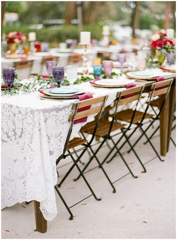 French bistro chairs at bohemian wedding with lace table cloth and colorful mismatched china by Ever After Vintage Weddings || The Ganeys