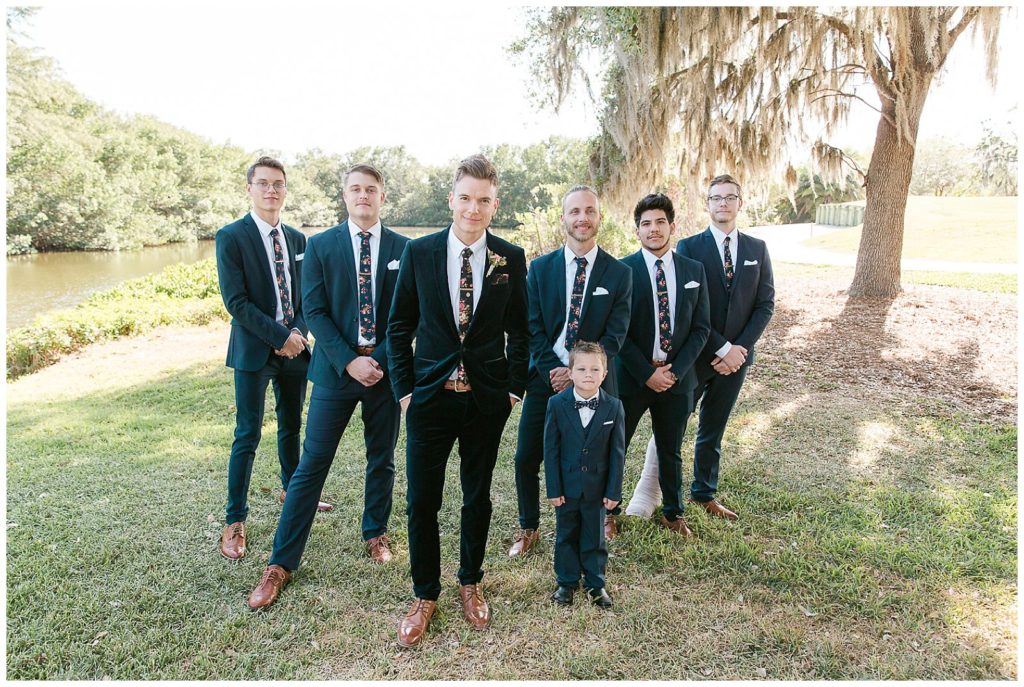Groomsmen in blue suits in backyard wedding