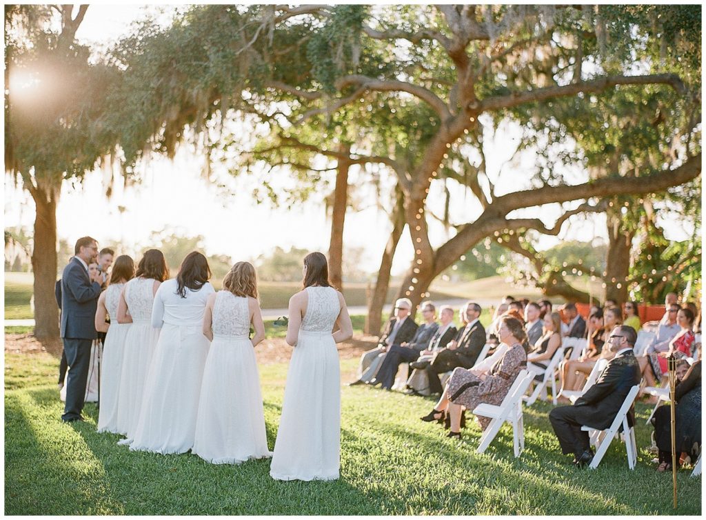 bridesmaids wearing white during wedding ceremony