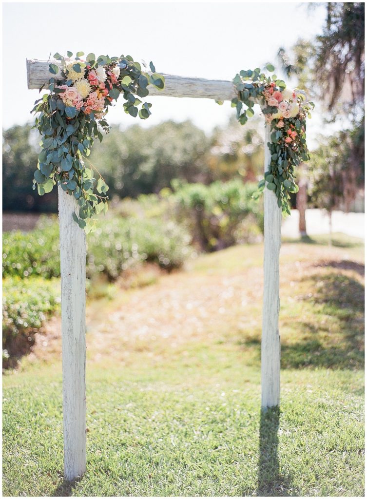 White wedding arch with flower details || The Ganeys