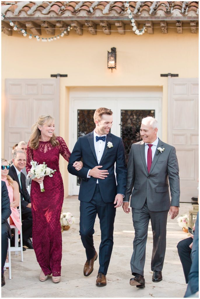 Groom walking down the aisle with parents at The Addison || The Ganeys