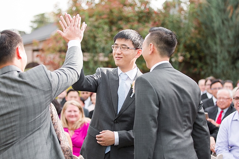 High fives for the groom at The Palm Event Center