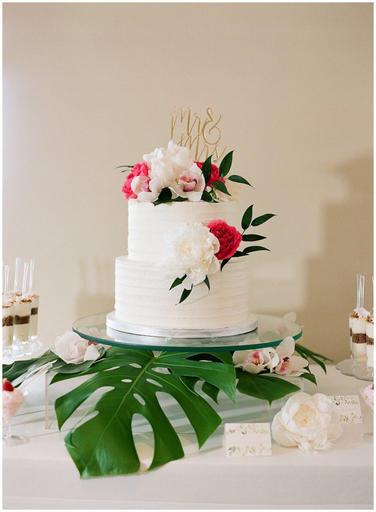 Tropical two tiered wedding cake by Hands On Sweets, topper by Here's to Us UK at the Don CeSar || The Ganeys