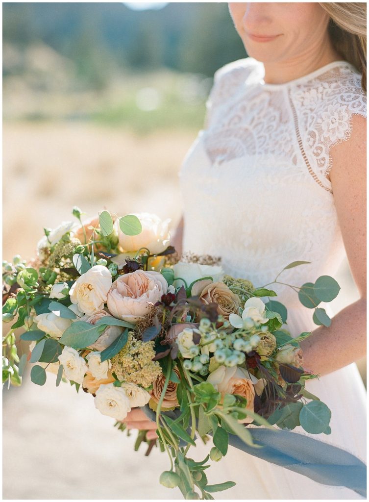 Dusty blue and peach bouquet with greenery by Lindsay Helzer Smith Rock State Park Elopement || The Ganeys