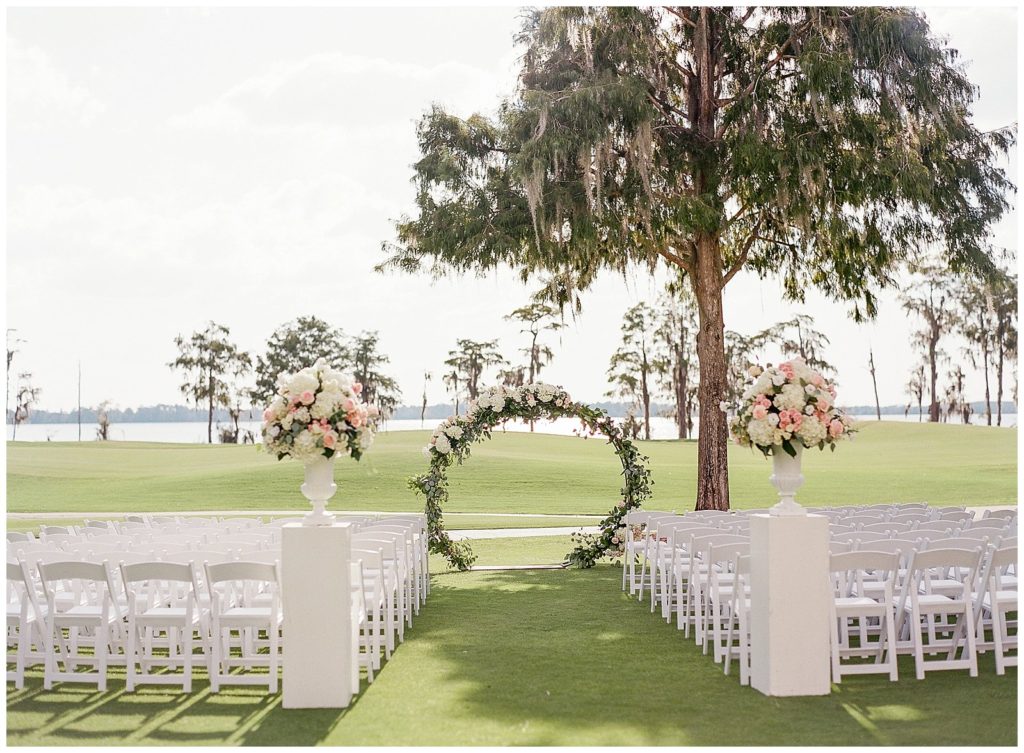 Wedding ceremony at Lake Nona Country Club with floral arch by Lee Forrest Design planned by Plan It Designs 