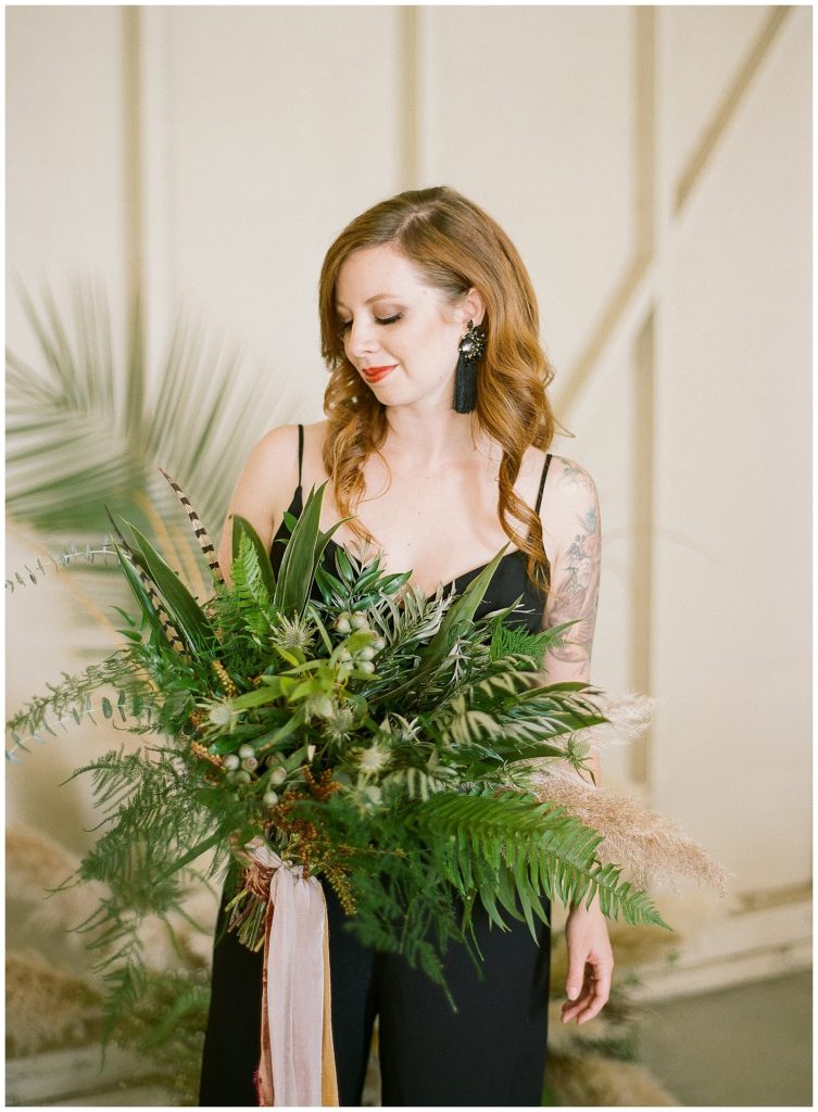Black bridal jumpsuit with greenery bouquet by Sarah's Garden Design || The Ganeys