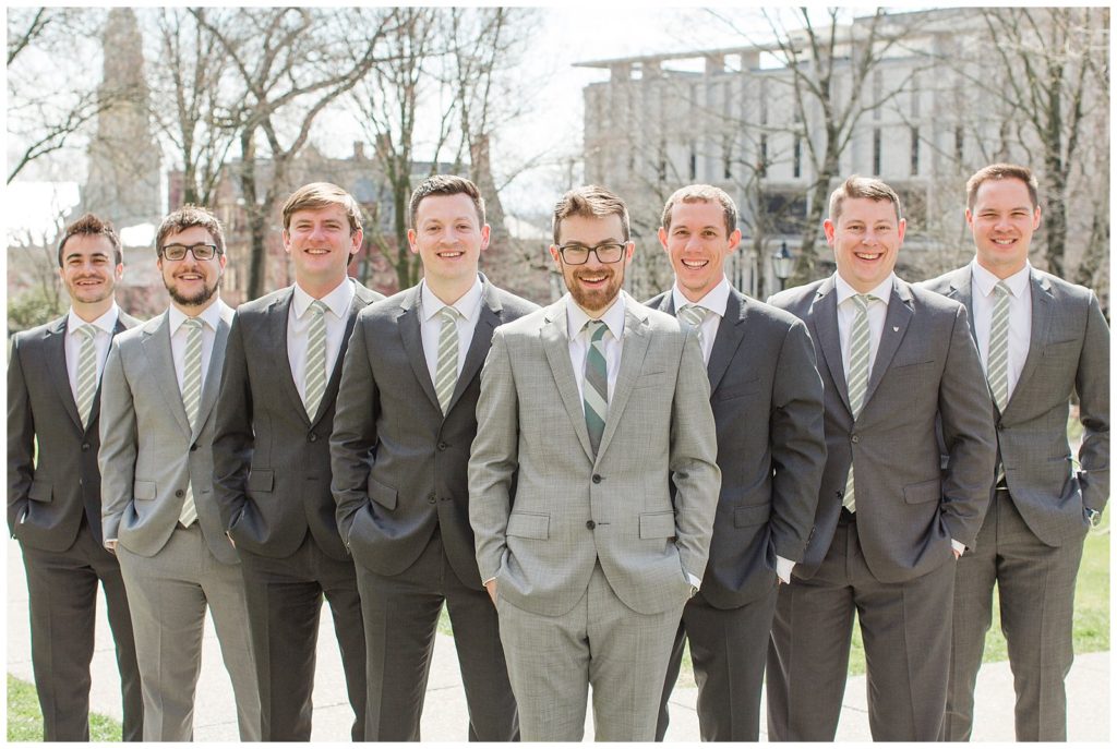 groomsmen in mismatched gray suits