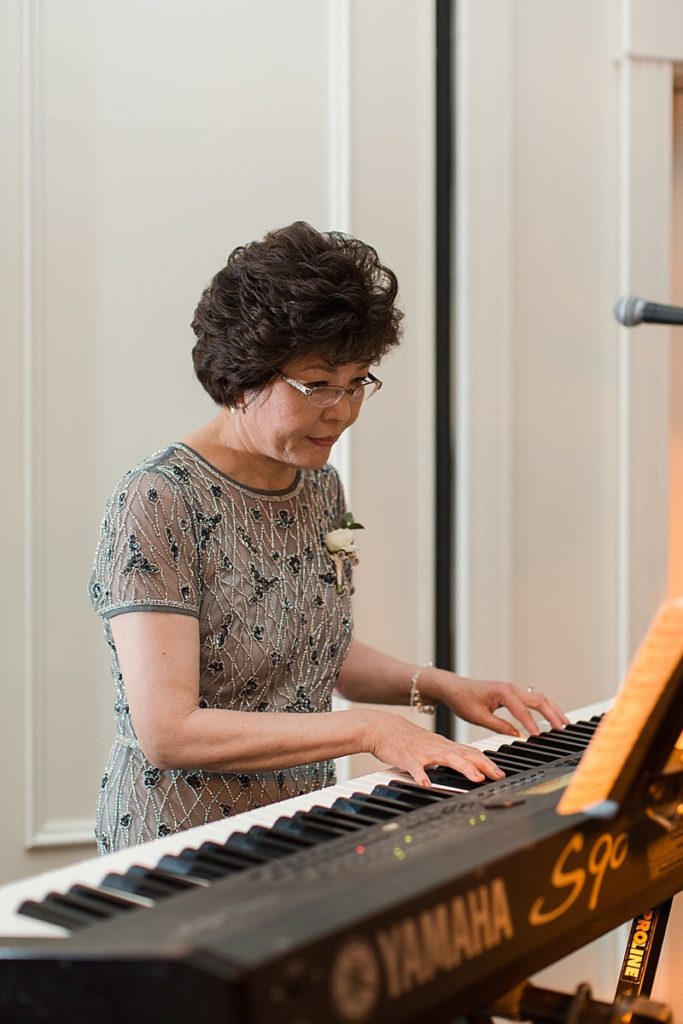 bride's mom plays piano during reception at Silverado Resort