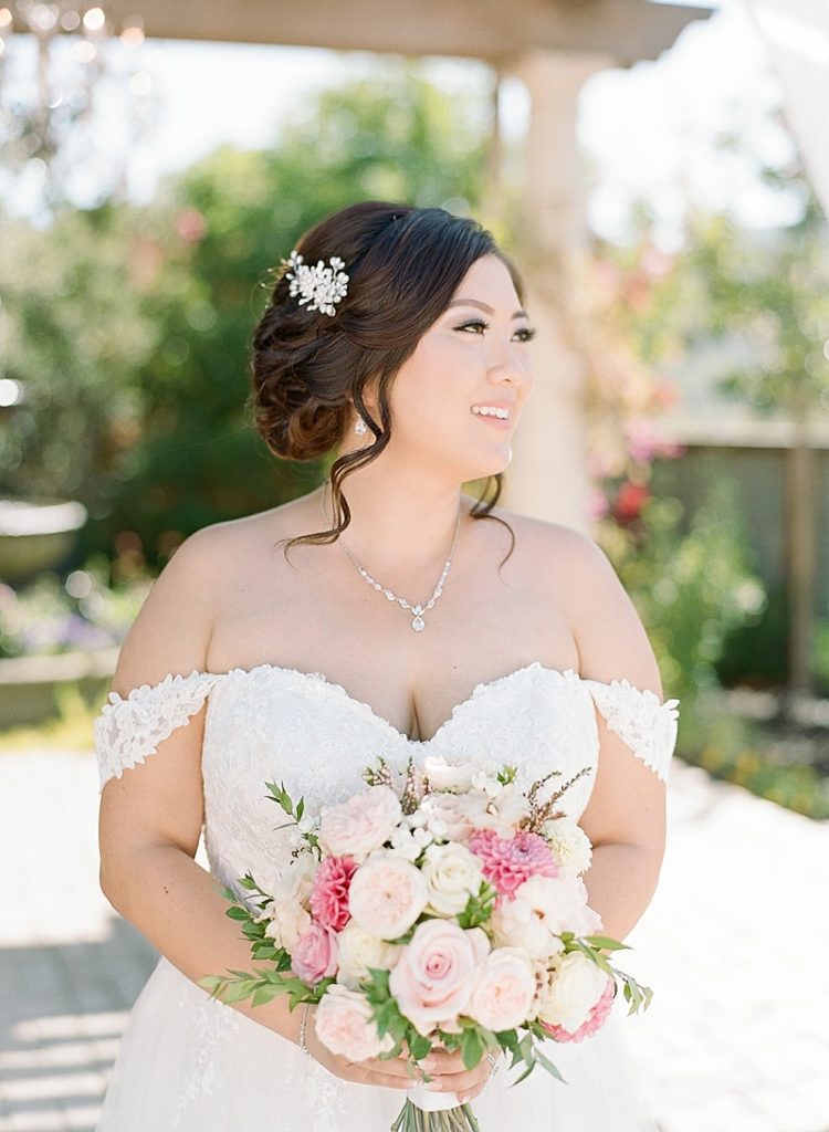 Bride in Miss Stella York wedding gown with lace sleeves and pink bouquet by My Wedding Sense || The Ganeys