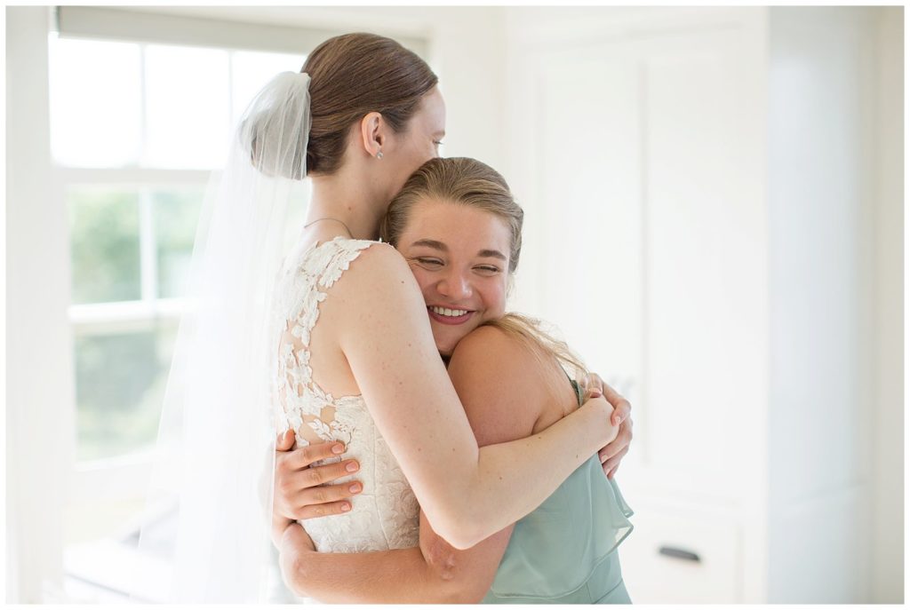 bride hugging bridesmaid before Chappaquiddick wedding
