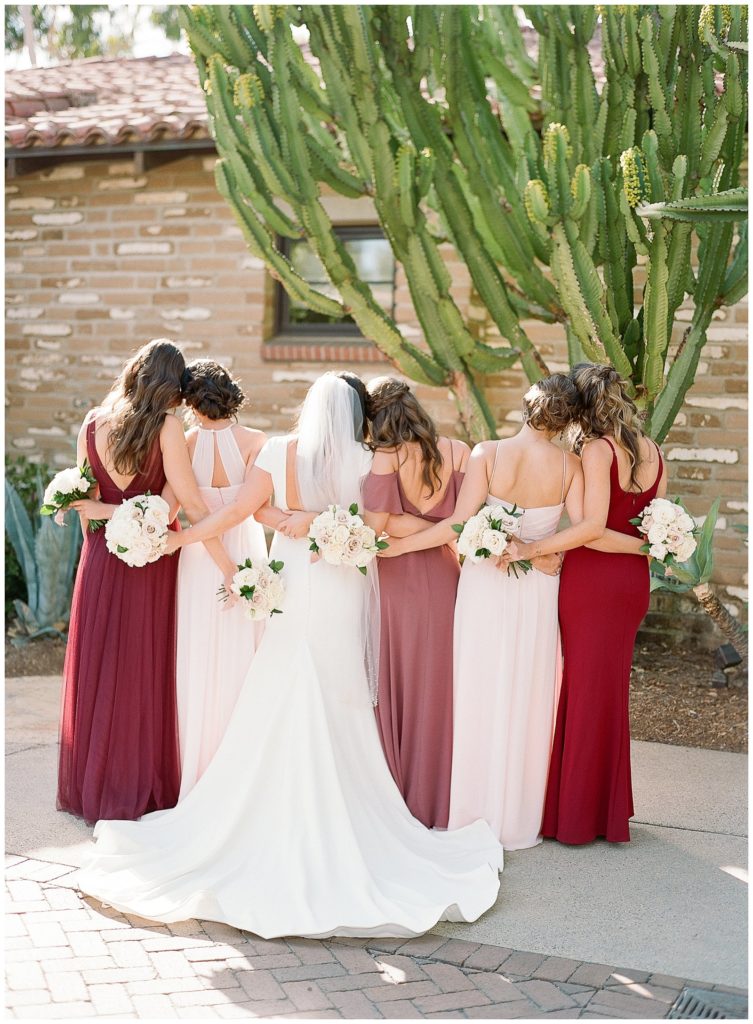mismatched berry toned bridesmaids dresses at Estancia La Jolla wedding venue || The Ganeys