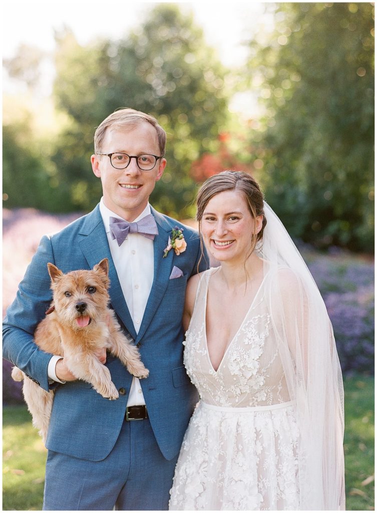 couple with Norwich terrier on wedding day || The Ganeys