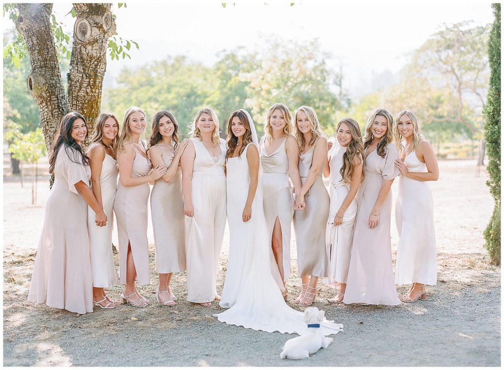 Bridesmaids wearing blush off white dresses