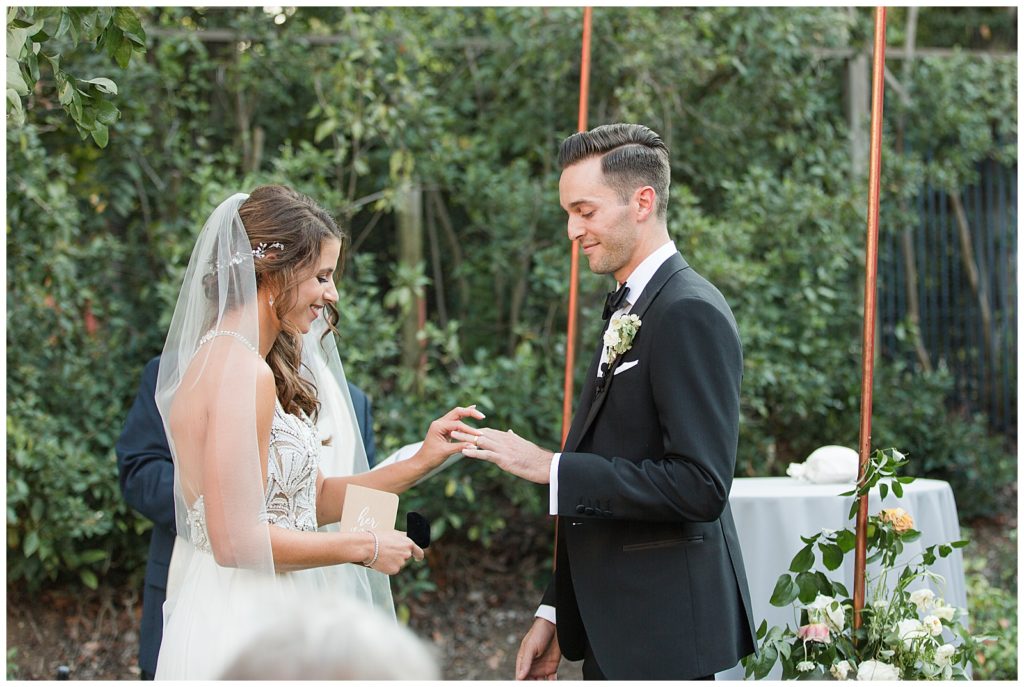 bride and groom exchanging rings during private estate wedding