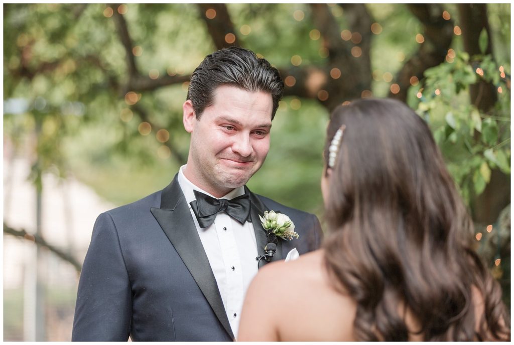 groom getting emotional during wedding vows