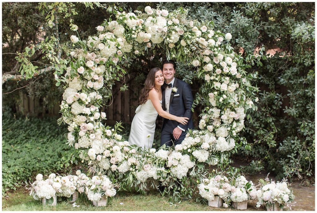 Just married under the floral arch