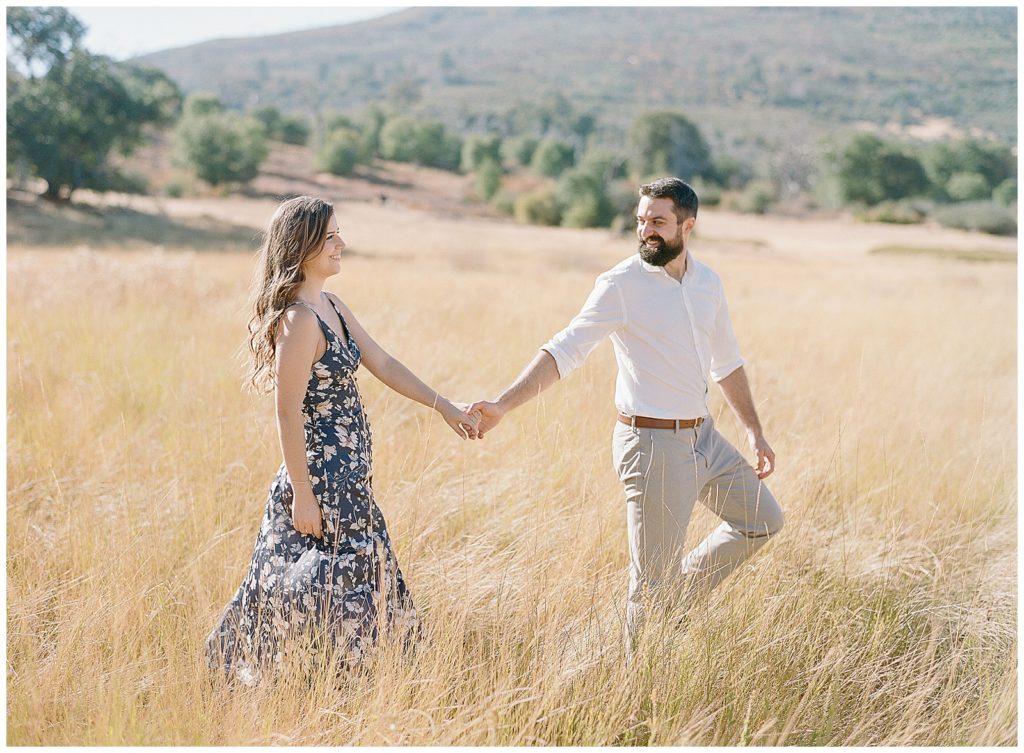 Field engagement photos with navy dress