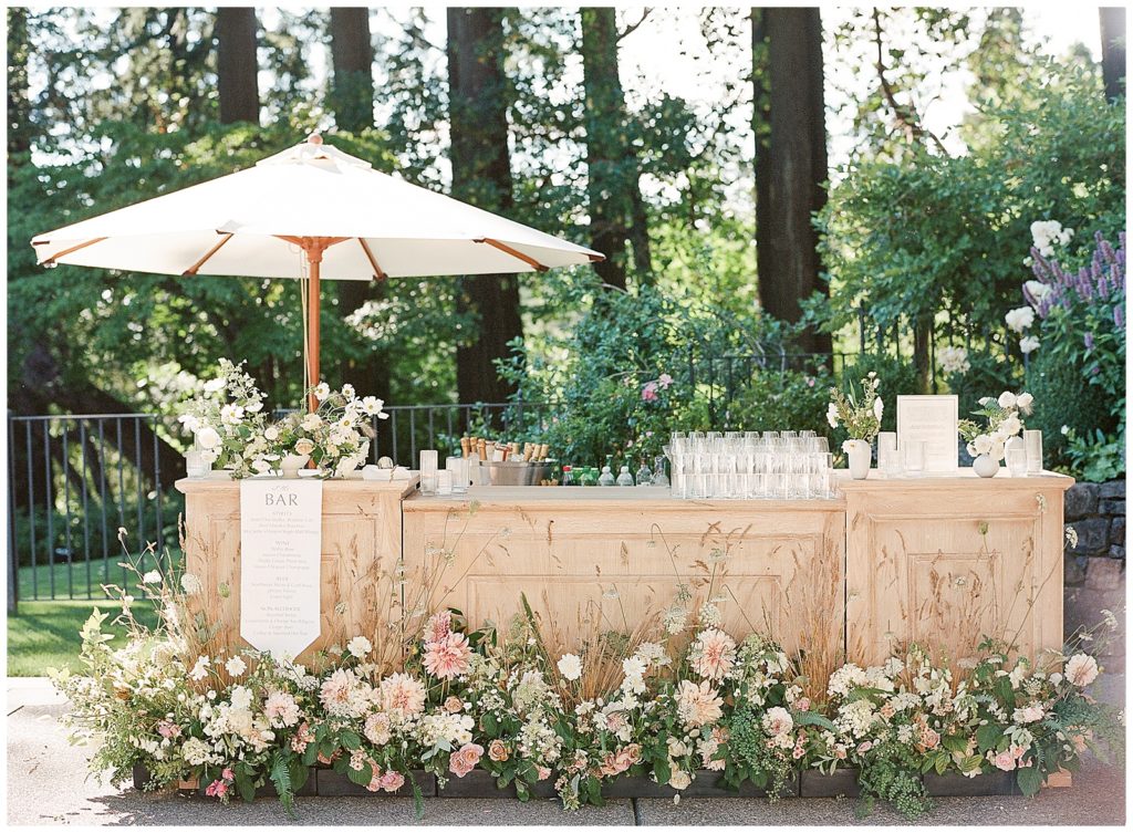 Wedding bar covered in florals by Gather Design Company