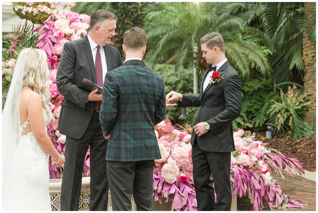 best man handing over the rings to officiant