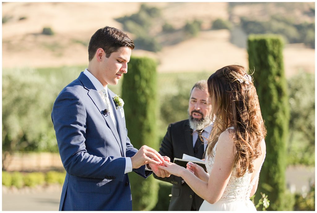 exchanging rings at Viansa Sonoma wedding