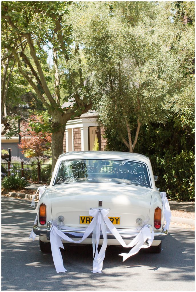 bride driving in Rolls Royce on wedding day