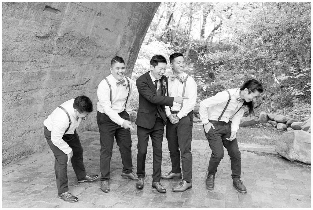 groom laughing with groomsmen on wedding day