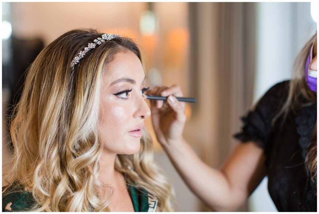bride getting makeup done at Fisher Island wedding