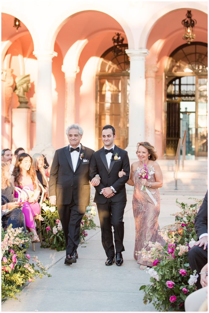 groom walking down the aisle with parents at Ringling Wedding