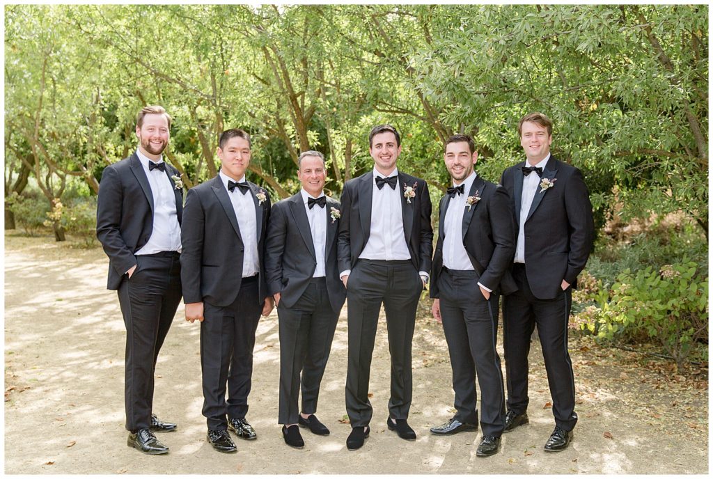 groom and groomsmen in black tuxes at Bear Flag Farm