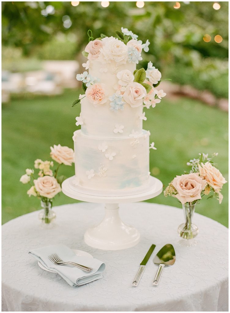 Three tiered watercolor wedding cake with sugar flowers