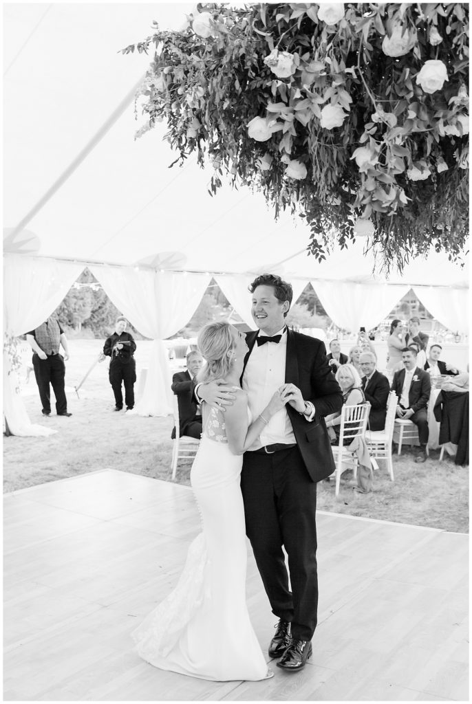first dance under floral chandelier in sailcloth tent wedding on Bainbridge Island
