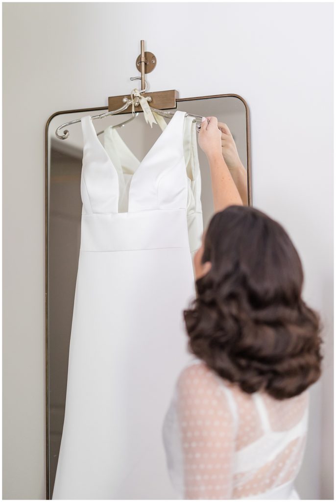 bride getting ready to put on her wedding dress