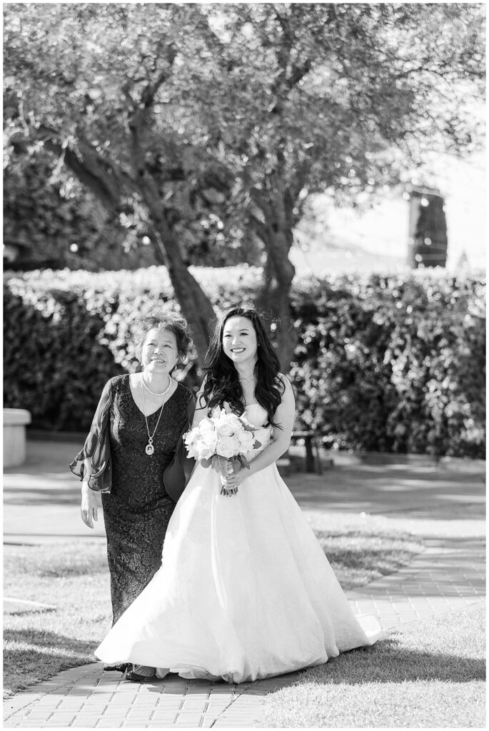 bride walking down aisle with mom