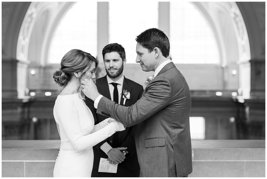 exchanging vows during SF City hall 4th floor balcony wedding 